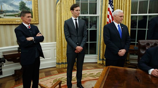 Jared Kushner, flanked by National Security Adviser Michael Flynn (left) and US Vice-President Mike Pence, watches his father-in-law Donald Trump sign his first executive order as US President.