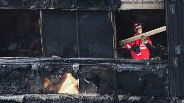 A London Fire Brigade officer inside the charred Grenfell Tower.