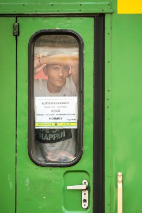 A man stands inside the door of the train he is refusing to leave in Bicske.