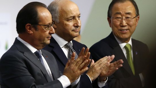 French President Francois Hollande, left, French Foreign Minister Laurent Fabius and UN Secretary-General Ban Ki-moon at the Paris climate conference on Saturday.