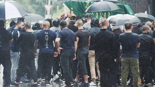 The coffin is carried to the hearse.