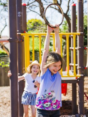 Sisters Olivia and Sophia Baker can keep playing in Narrabundah playground after the ACT government decided to repair it.