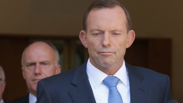 Seeking an election trigger? Prime Minister Tony Abbott with senators Eric Abetz and George Brandis. 