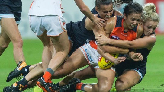 Rebecca Beeson of the Giants is tackled during the GWS Giants and Carlton game at Drummoyne Oval.