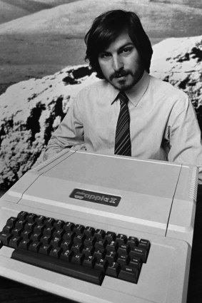 Apple co-founder Steve Jobs holding an Apple II computer in 1977.