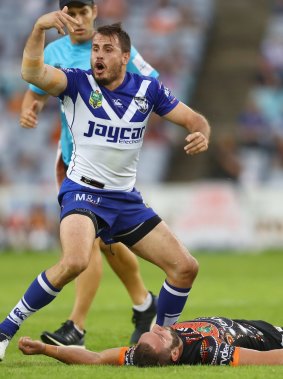 Josh Reynolds gestures frantically for Robbie Farah to receive medical attention.