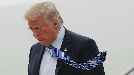 President Donald Trump walks down the stairs of Air Force One during his arrival at Andrews Air Force Base.