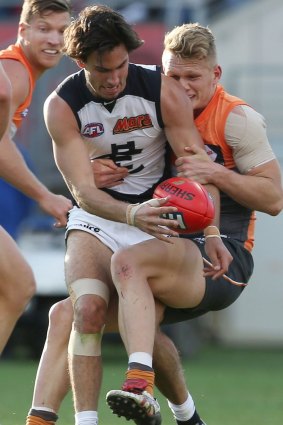 Competitor: Adam Treloar of the Giants tackles Troy Menzel of the Blues. 