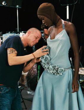 Alexander McQueen adjusts a model's dress in the documentary <i>McQueen</i>.