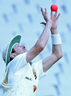 Tamania's Andrew Fekete takes a catch to dismiss Peter Handscomb.