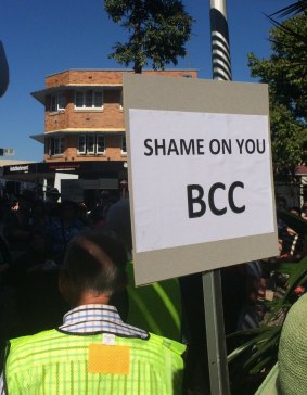 A woman at the protest makes her thoughts on the Brisbane City Council clear.