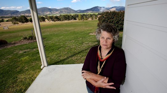 Denise Gilbert at her Forbesdale residence near Gloucester, which overlooks the proposed Rocky Hill coal mine, pictured in the background.