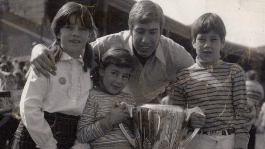 Caroline Wilson with sister Amelia, brother Will, Bill Barrot and the Richmond 1969 premiership cup.