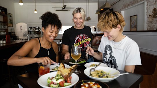 Claire Browne (left) and Otis Clark, right, try chef Lizzie Tillett's vegan and vegetarian food at The Sunshine Inn in Redfern. 