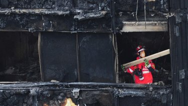 A London firefighter inside the charred Grenfell Tower on June 17, 2017.