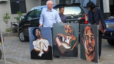 Bali nine lawyer, Julian McMahon, with three recent paintings by Myuran Sukumuran, among them one marked "Self Portrait, 72 hours just started" as Sukumuran began the countdown to his execution.