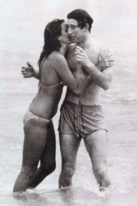 Model Jane Priest kisses Prince Charles in the surf at Cottesloe in Western Australia.
