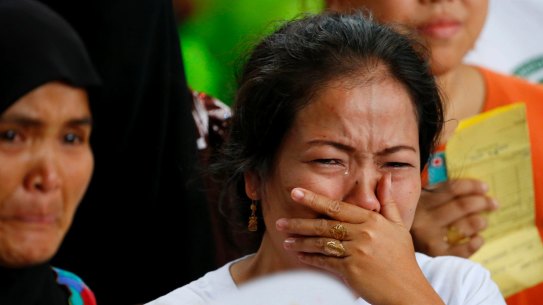 Displaced residents of Marawi city cry upon receiving assurance of support from local officials at an evacuation centre in Balo-i township, Lanao del Norte province,  on Wednesday.
