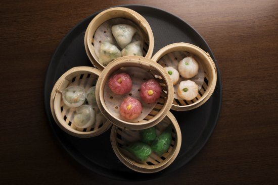 Steamed vegan dumplings of many colours.