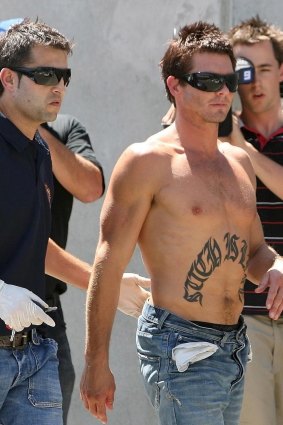 Ice addict and former AFL star Ben Cousins is led away by Police in 2007.