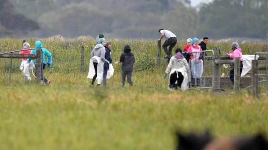 Potential illegal workers try to flee during a Border Force raid on Vizzarri Farms in Koo Wee Rup, Victoria.
