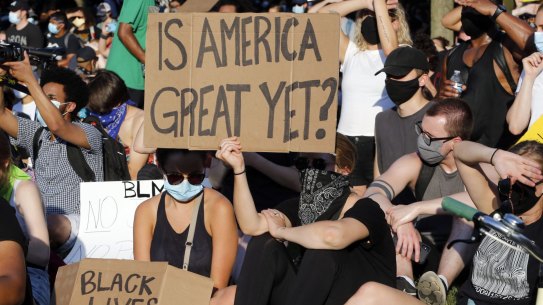 A large group of protesters gather around the statue of Confederate General Robert E. Lee on Monument Avenue Tuesday, June 2, 2020, in Richmond, Va. The crowd protesting police brutality chanted "Tear it down." (AP Photo/Steve Helber)