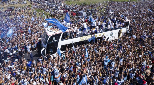 The Argentine soccer team that won the World Cup title ride on an open bus during their homecoming parade in Buenos Aires, Argentina.