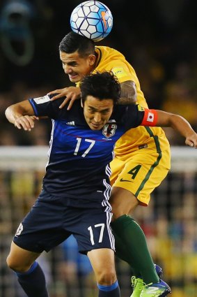 Tim Cahill wins a header from Makoto Hasebe as the Socceroos drew 1-1 with Japan.