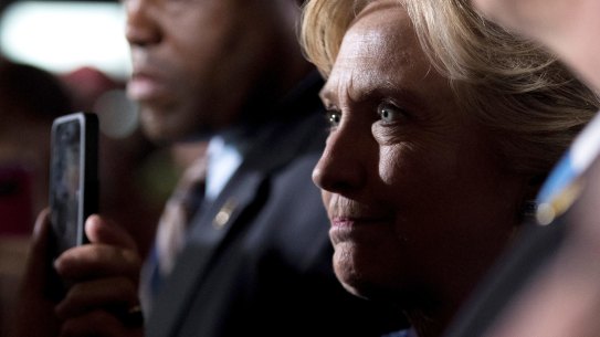 Democratic presidential candidate Hillary Clinton greets members of the audience after speaking at a rally at Theodore Roosevelt High School.