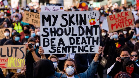 This afternoon in Sydney, hundreds marched against the injustices of over 400 indigenous Australian deaths whilst in custody throughout Australia. This evening was also in solidarity with those across America  who have take to the streets across the states, seeking justice for  George Floyd, who last week died at the hands of Minneapolis police officers. Sydney Town Hall. Saturday 6th June 2020. Photograph James Brickwood. SMH NEW 200606 Coronavirus COVID-19