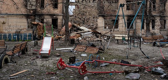 HOSTOMEL, UKRAINE - APRIL 06: A damaged playground is seen next to a heavily damaged apartment building on April 6, 2022 in Hostomel, Ukraine. Hostomel was occupied for more than a month by Russian forces as they pushed toward the Ukrainian capital, before ultimately retreating to Belarus last week. (Photo by Alexey Furman/Getty Images)