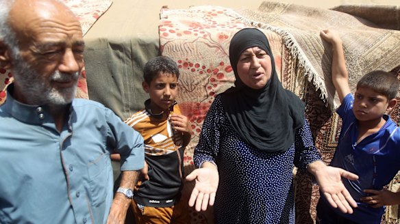 Iraqi families, who fled the city of Ramadi after it was seized by Islamic State militants, talk to journalists at a camp in Bzeibez, on the south-western frontier of Baghdad on Monday. 