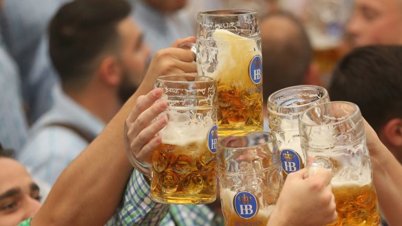 Oktoberfest visitors cheer with the traditional one-litre beer mugs.