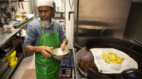 Zafar Khan prepares murtabak at his Pakistani restaurant Ali.