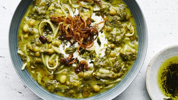 Greens, beans and noodle soup garnished with crispy onions.