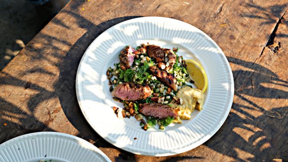 Moroccan-spiced lamb steaks with herby barley tabbouleh, hummus and dukkah.