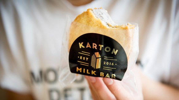 A customer eating an ice-cream sandwich.