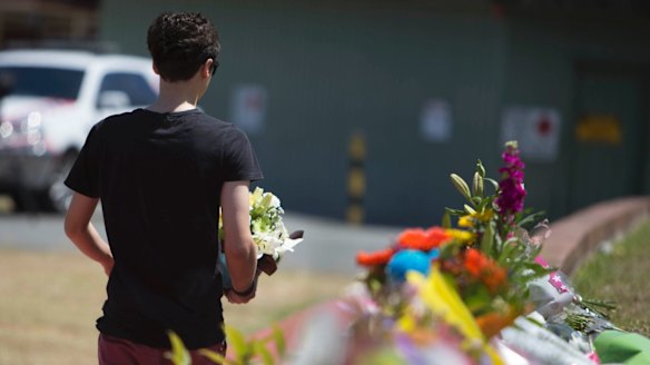 Locals laying flowers at Dreamworld where four people died after a malfunction on the Thunder River Rapids ride.