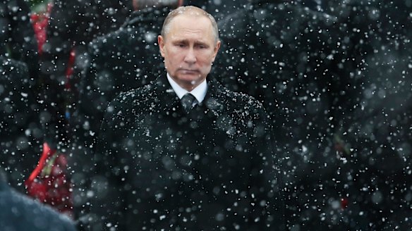 Snow falls as Russian President Vladimir Putin attends a wreath-laying ceremony at the Tomb of the Unknown Soldier in Moscow, Russia.