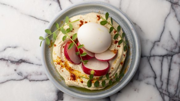 The tahini-rich hummus comes with crunchy radish and a cold smoked, soft boiled egg.