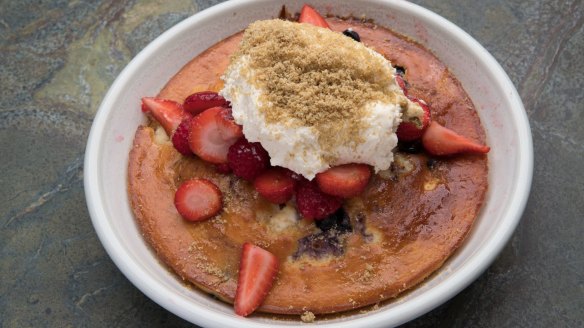 Ricotta hotcake with berries and whipped cream.