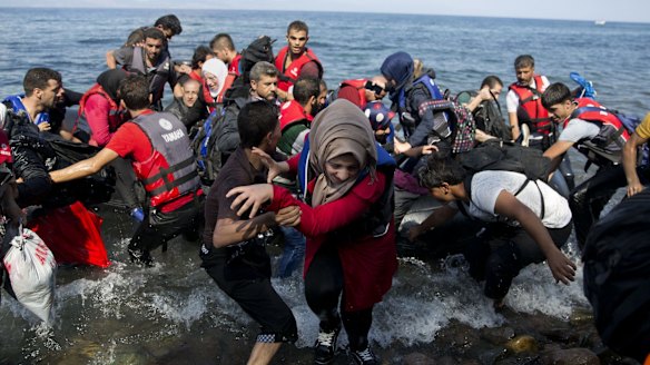 Migrants and refugees arrive on a dinghy after crossing from Turkey to Lesbos Island, Greece. The island of some 100,000 residents has been transformed by the sudden new population of some 20,000 refugees and migrants, mostly from Syria, Iraq and Afghanistan.