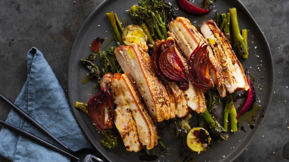 Neil Perry's roast pork belly with braised dark greens.