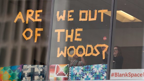 Workers in support of pop singer Taylor Swift in office across from the federal courthouse put up a new sign as the jury gets the case in the civil trial involving the singer in a case in federal court Monday, August 14, 2017, in Denver.
