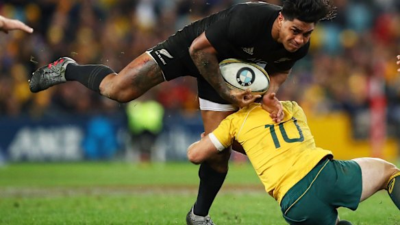 Hard man to stop: Malakai Fekitoa steamrolls Bernard Foley.