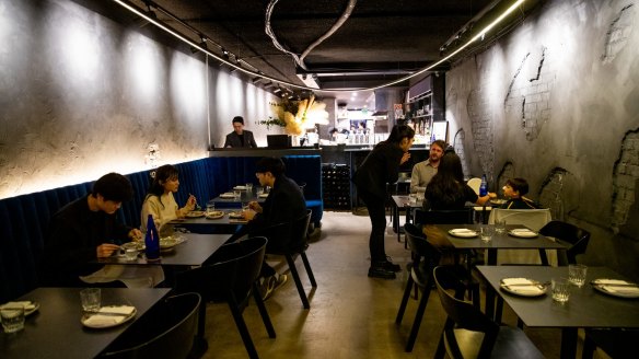 The 12-metre loop of halo lighting, blue velvet banquettes and distressed, charcoal-daubed walls at Soul Dining.