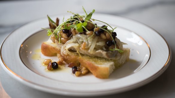 Sardine with pickled onion, toasty pinenuts and blackcurrants on a slice of focaccia.