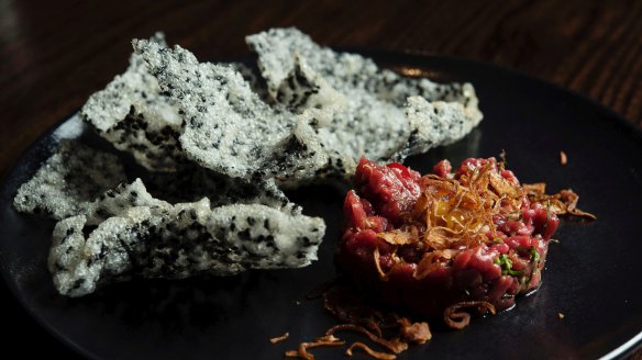 Hand-cut Cape Grim beef tartare with black sesame crackers.