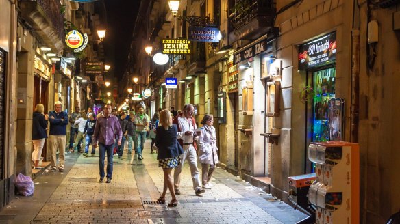 People stroll on a street in San Sebastian, Basque Country, Spain. 