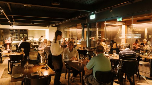 The Gantry's solid timber dining room, framed by walls of wine and open kitchens.